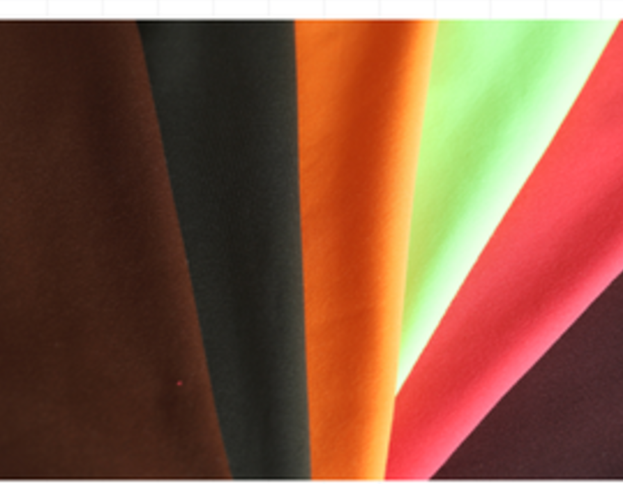 Fan of brushed solid knit swatches in warm browns, orange and red.